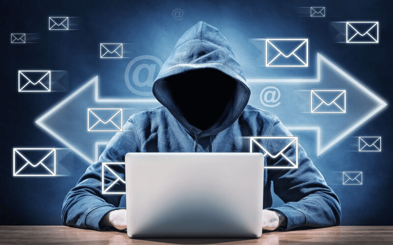 BlackCloak Hacker in hoodie typing on laptop