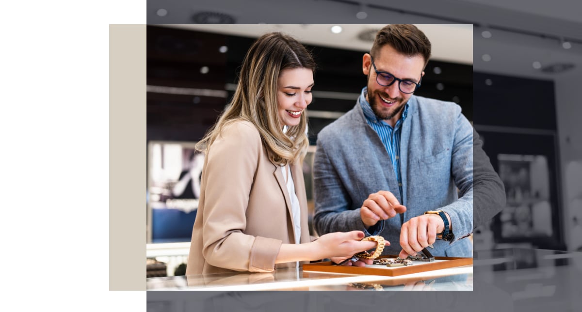 A man and woman browse luxury items in a high-end retail store, unaware of data breach affecting customer information--highlighting the need for holistic cybersecurity.