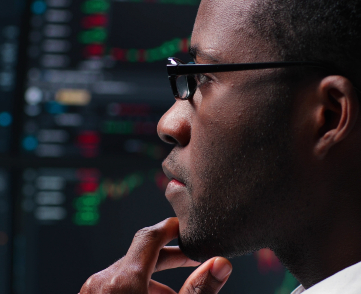 Programmer looking at computer monitors with graphs. Trader analyze stock market data