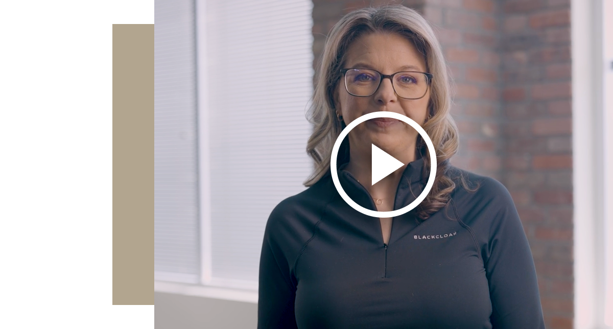 Video thumbnail for a reputation management video featuring a woman with glasses wearing a black shirt with the BlackCloak logo, centered with a large white play button overlay.