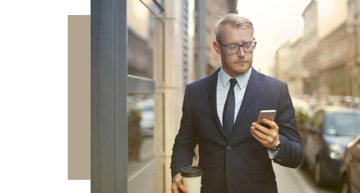 Man in suit looking at phone