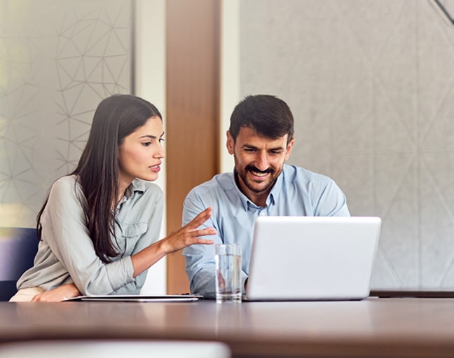 Man and woman working on a laptop